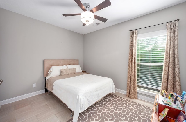 588 E Church St, Alamo, TN 38001 - bedroom with baseboards, visible vents, light wood-style flooring, and a ceiling fan