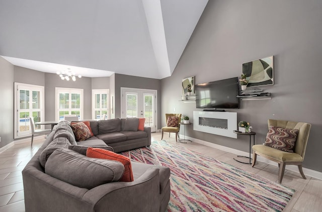 588 E Church St, Alamo, TN 38001 - living area with high vaulted ceiling, a glass covered fireplace, a chandelier, and baseboards