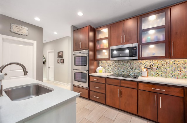 588 E Church St, Alamo, TN 38001 - kitchen with light countertops, appliances with stainless steel finishes, a sink, and glass insert cabinets