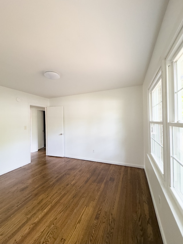 empty room featuring dark hardwood / wood-style flooring