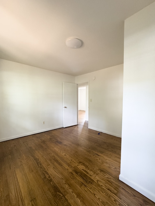 spare room with dark hardwood / wood-style floors