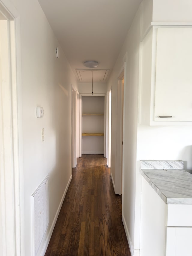 hallway with dark hardwood / wood-style floors