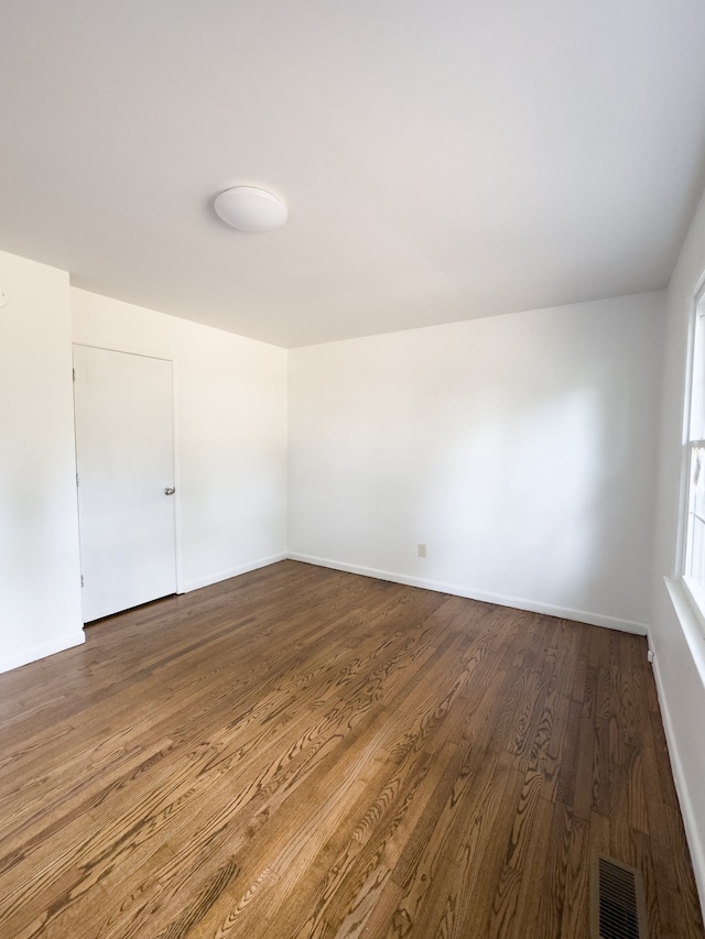 spare room with hardwood / wood-style flooring