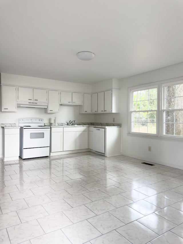 kitchen featuring sink, white appliances, white cabinetry, and light tile patterned floors