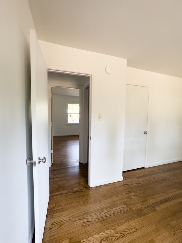 unfurnished room featuring dark hardwood / wood-style flooring