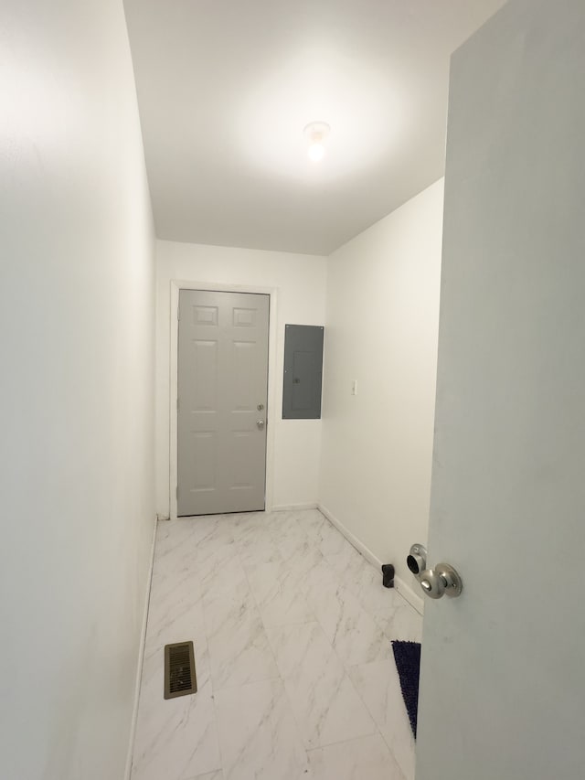 laundry room with electric panel and light tile patterned floors