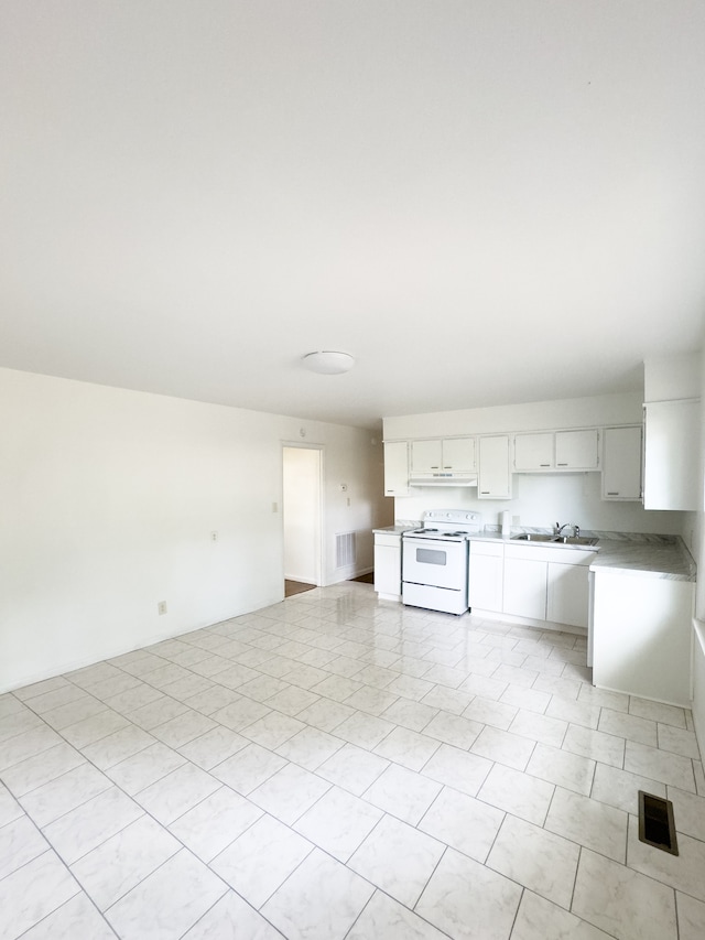 interior space featuring white cabinetry, electric stove, and light tile patterned flooring