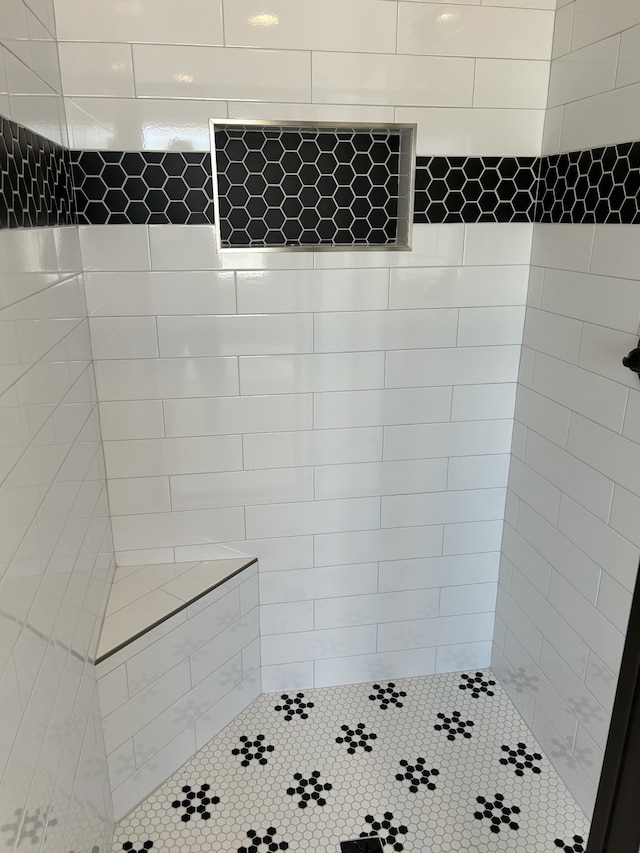 bathroom with tiled shower