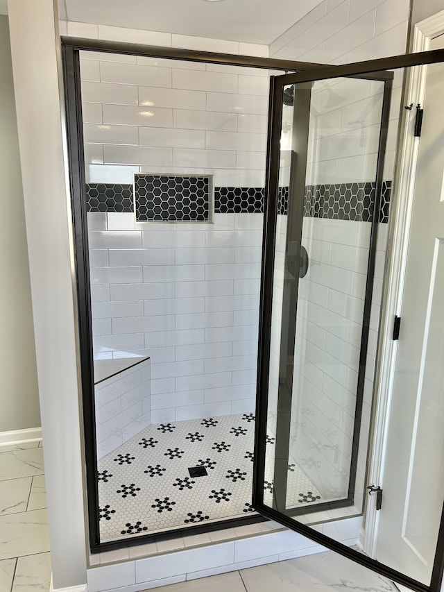 bathroom with a shower with shower door