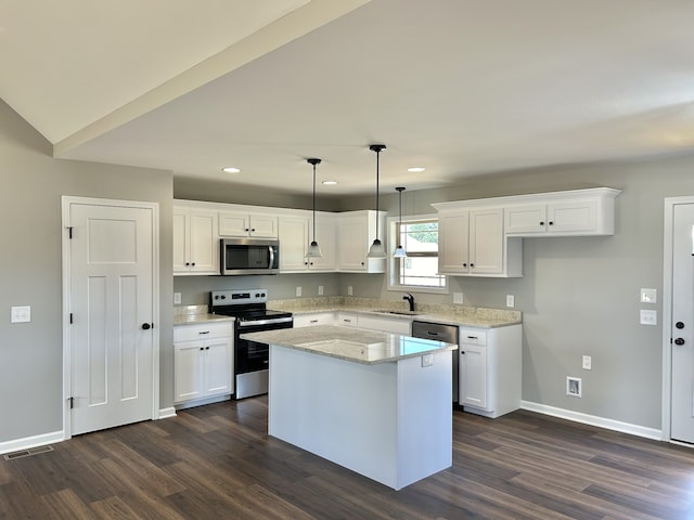 kitchen with pendant lighting, a center island, stainless steel appliances, and white cabinetry