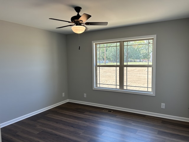 empty room featuring dark hardwood / wood-style floors and ceiling fan