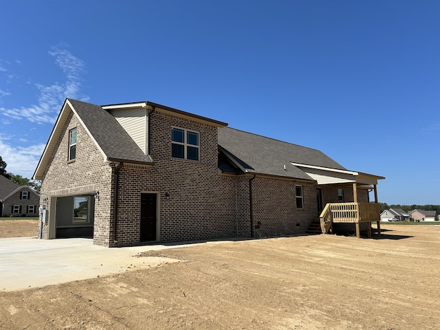 back of property featuring a garage