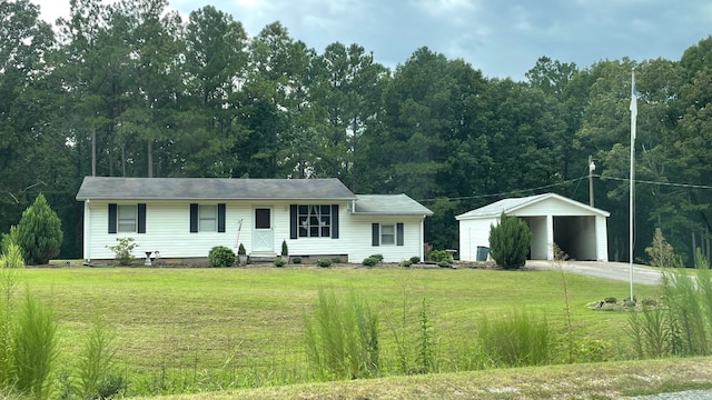 ranch-style house featuring a carport, an outbuilding, and a front lawn