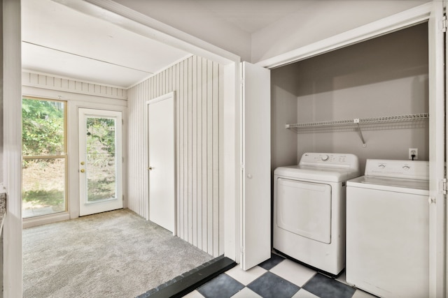 clothes washing area featuring light tile patterned floors and washing machine and dryer