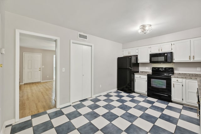 kitchen featuring black appliances, white cabinetry, and light tile patterned floors