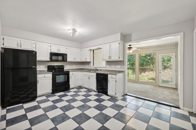 kitchen with black appliances, white cabinetry, ceiling fan, sink, and light colored carpet