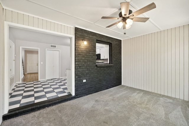 carpeted empty room featuring ceiling fan