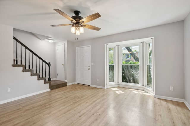 foyer entrance with light wood-type flooring and ceiling fan