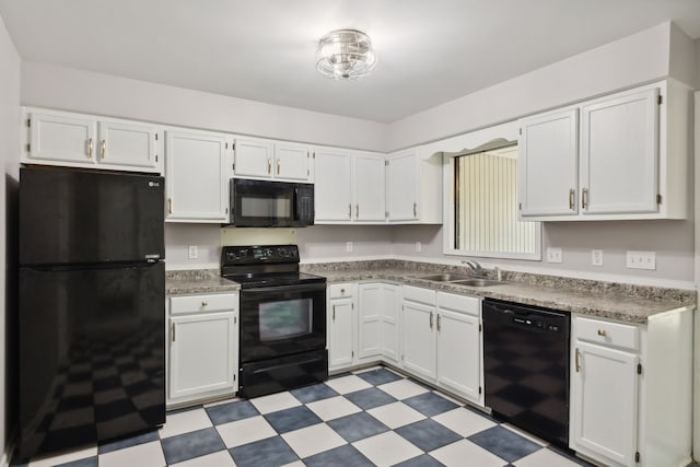 kitchen featuring light tile patterned floors, sink, black appliances, and white cabinetry