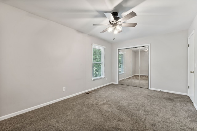 unfurnished bedroom featuring ceiling fan, carpet flooring, and a closet