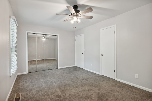 unfurnished bedroom featuring ceiling fan, a closet, and carpet floors