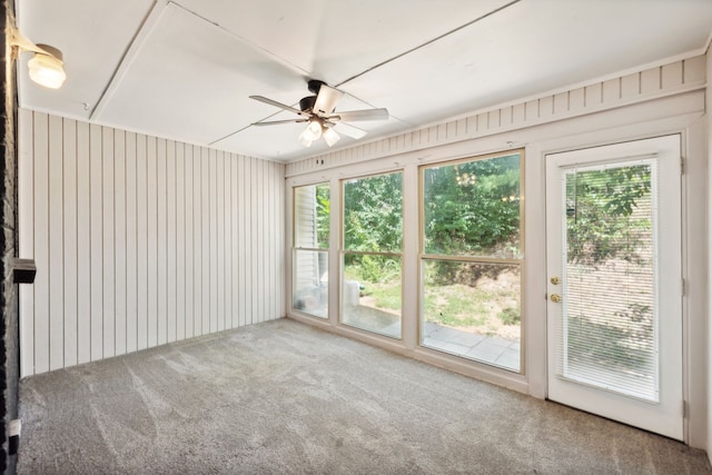 carpeted empty room featuring ceiling fan