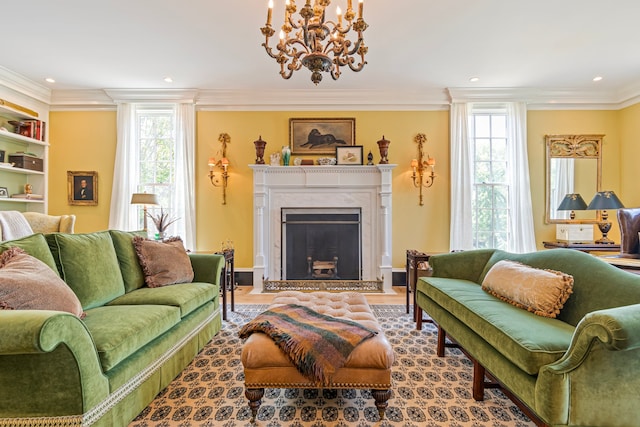 living room featuring a fireplace, ornamental molding, an inviting chandelier, and wood-type flooring