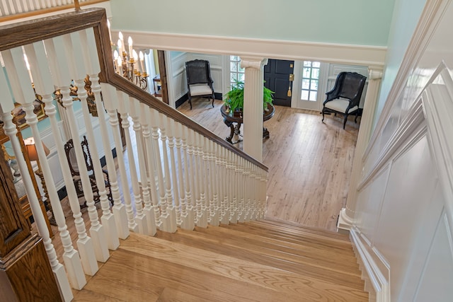 staircase featuring wood-type flooring and a chandelier