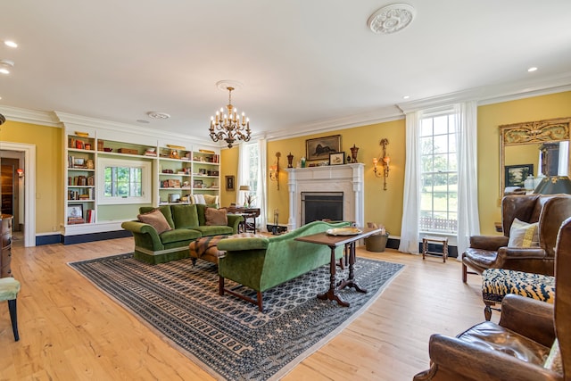 living room featuring crown molding, light hardwood / wood-style flooring, and a chandelier