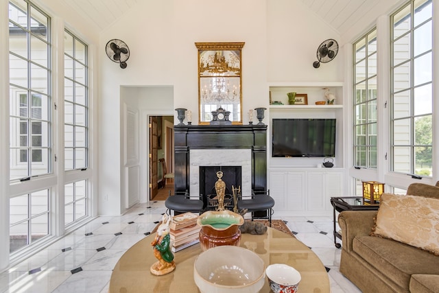 living room featuring high vaulted ceiling, light tile patterned floors, and a healthy amount of sunlight