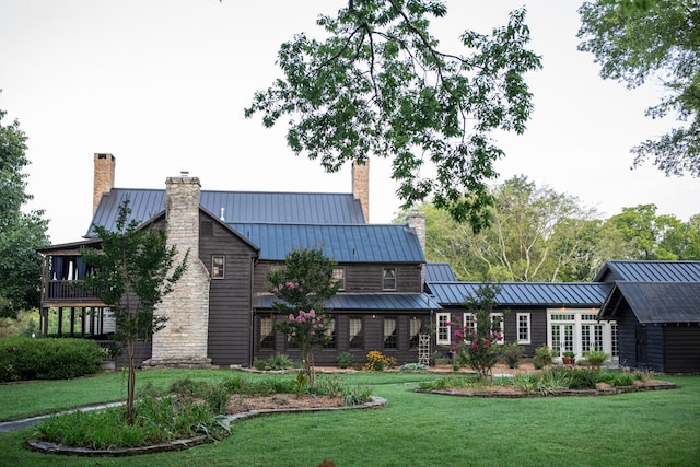 rear view of property with a yard