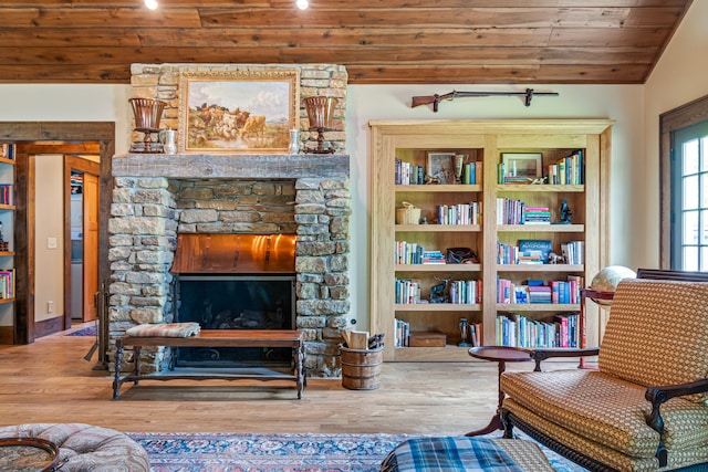 sitting room with lofted ceiling, a fireplace, hardwood / wood-style flooring, and wooden ceiling