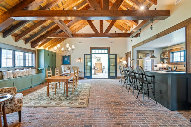 living room featuring a notable chandelier, high vaulted ceiling, beam ceiling, and wood ceiling