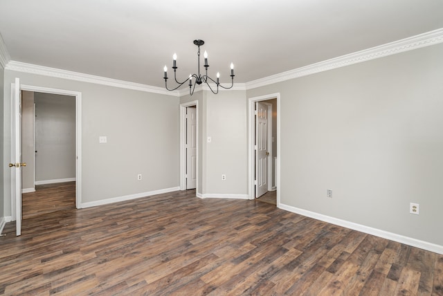 unfurnished room featuring dark hardwood / wood-style floors, crown molding, and an inviting chandelier