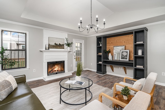 living room featuring a chandelier, dark hardwood / wood-style flooring, crown molding, and lofted ceiling