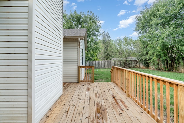 wooden terrace featuring a lawn