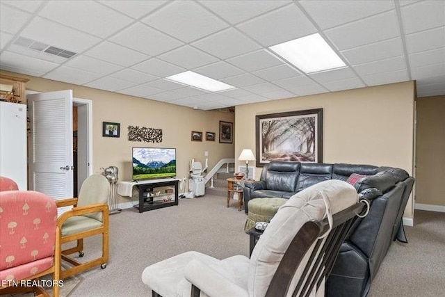 living area with carpet flooring, a paneled ceiling, and baseboards