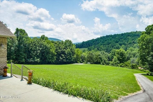 exterior space with a wooded view and a lawn