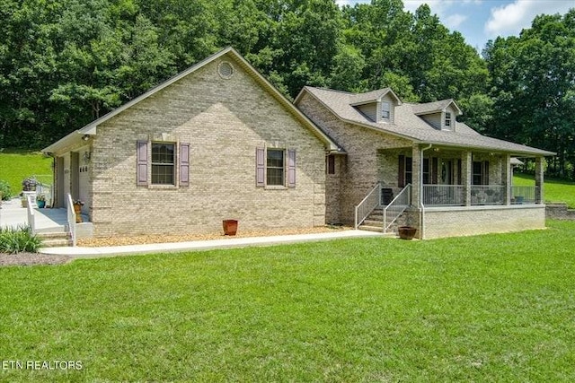 exterior space with covered porch, brick siding, and a yard