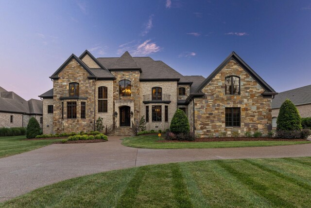 french provincial home featuring a yard