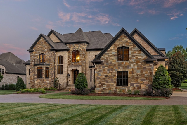 french country style house with a lawn