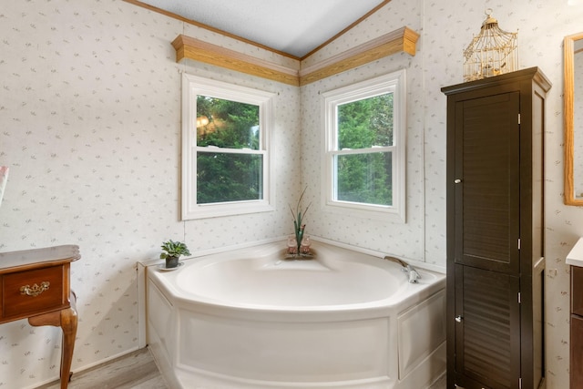 bathroom featuring lofted ceiling, vanity, wood-type flooring, and a tub