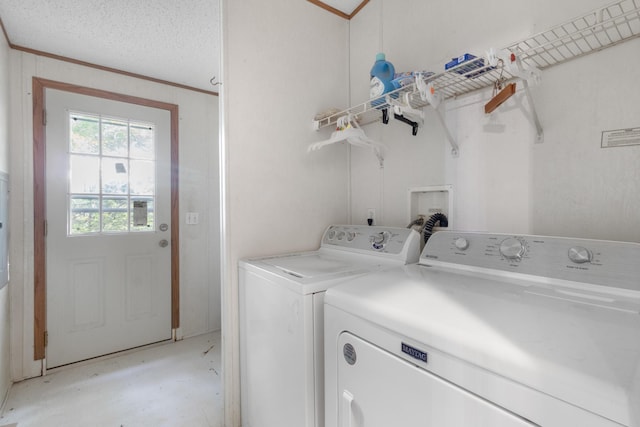 laundry room featuring separate washer and dryer, crown molding, and a textured ceiling