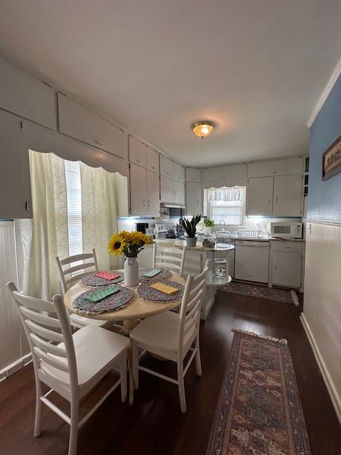 dining room with crown molding, plenty of natural light, and dark hardwood / wood-style flooring