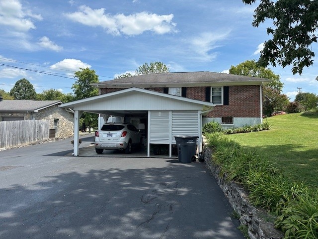 view of side of property featuring a carport and a yard