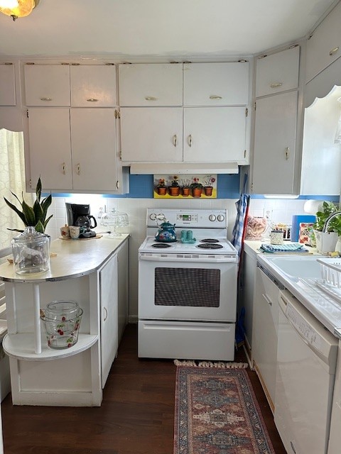 kitchen with white cabinets, tasteful backsplash, white appliances, and dark hardwood / wood-style floors