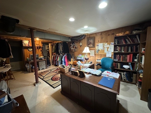 office space featuring wood walls