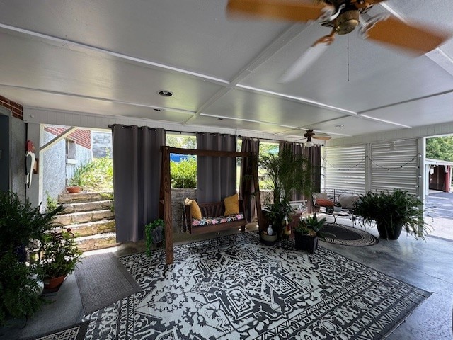 sunroom featuring ceiling fan