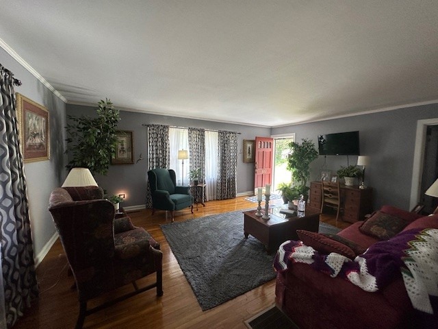 living room with ornamental molding and wood-type flooring