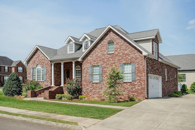 view of front facade with a garage and a front lawn